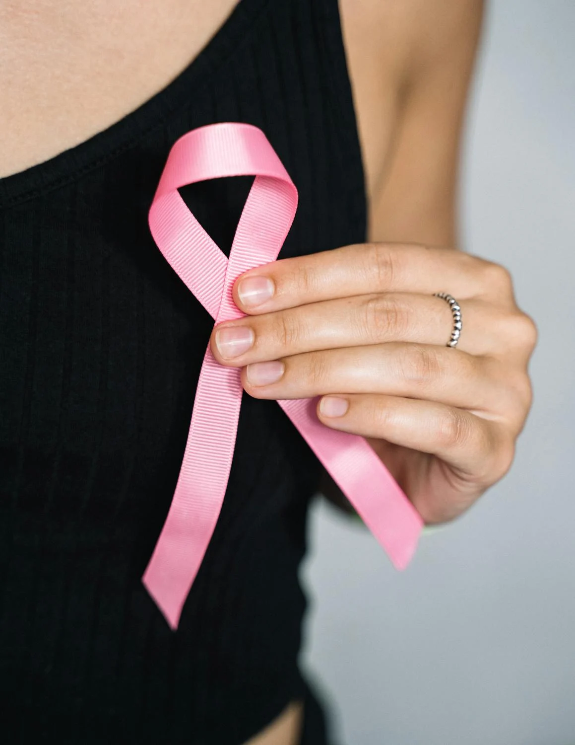 woman holding pink ribbon