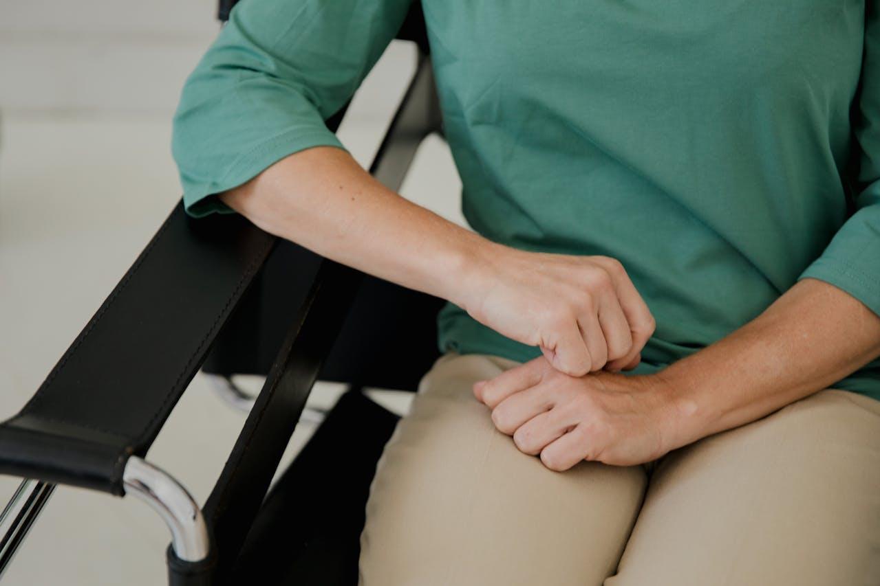 person resting elbow on chair