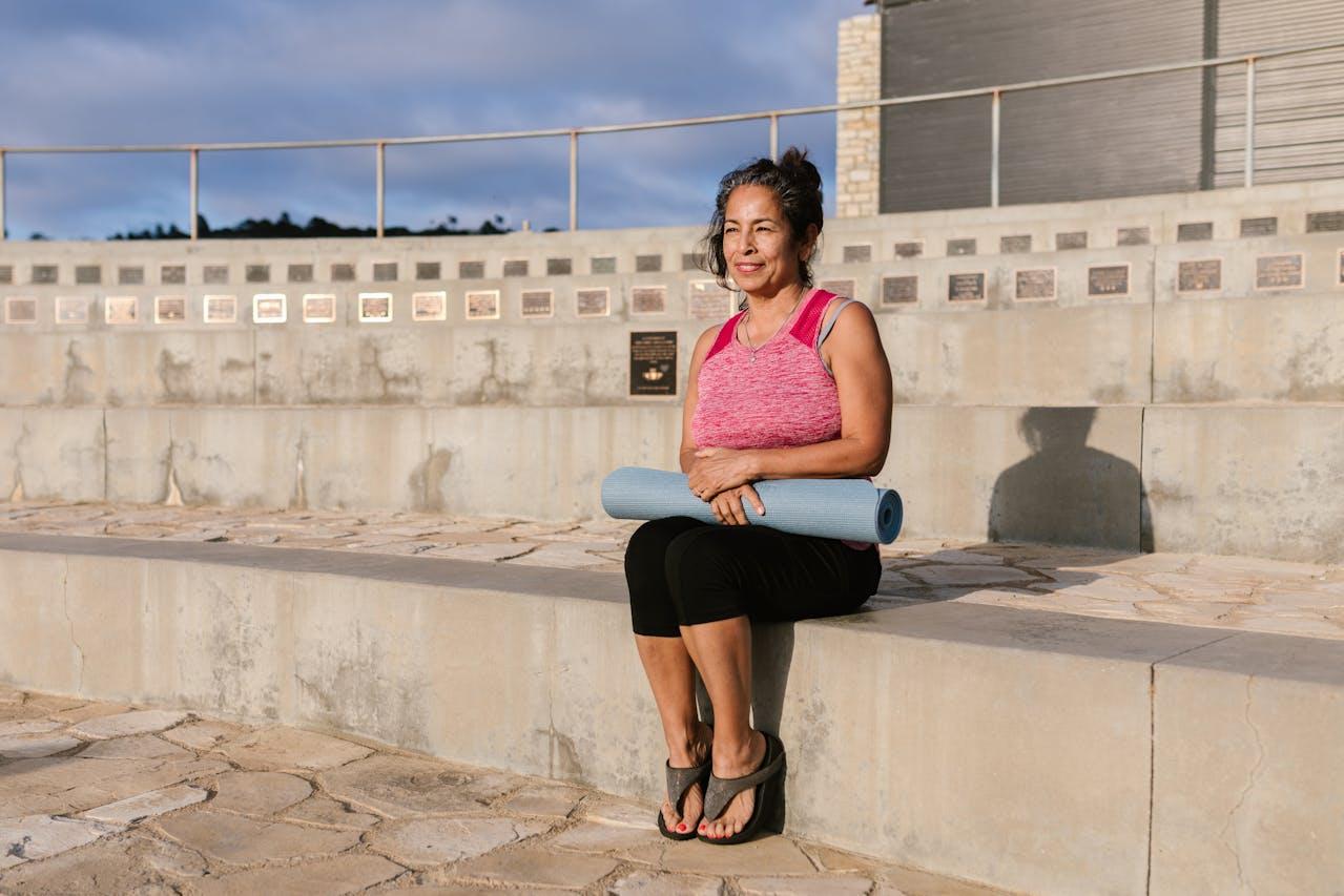 woman holding yoga mat