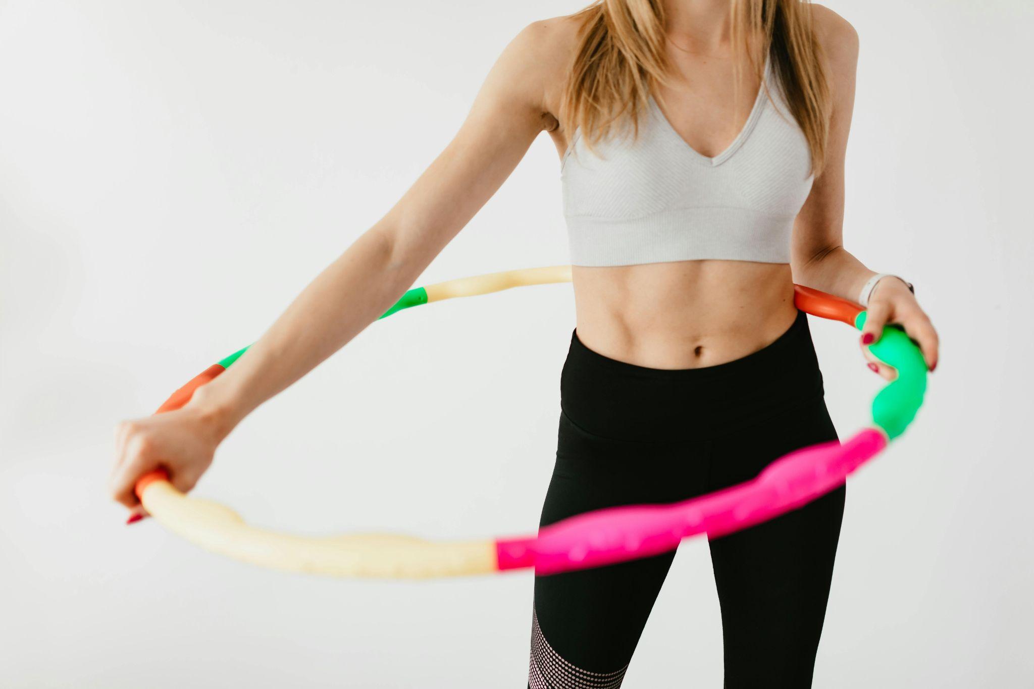 fit woman using hula hoop