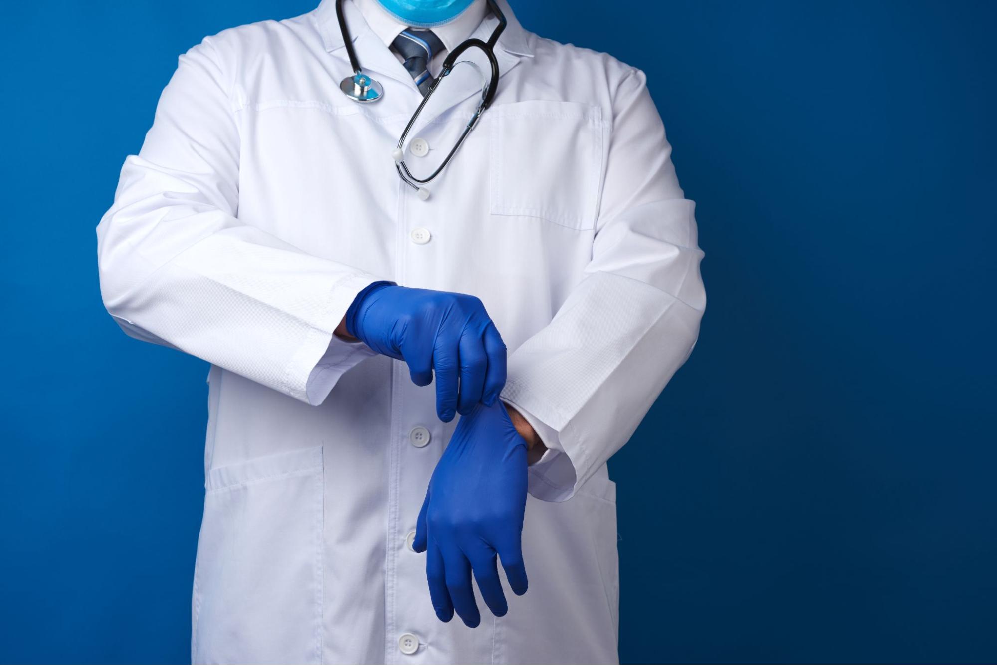 doctor putting on latex gloves