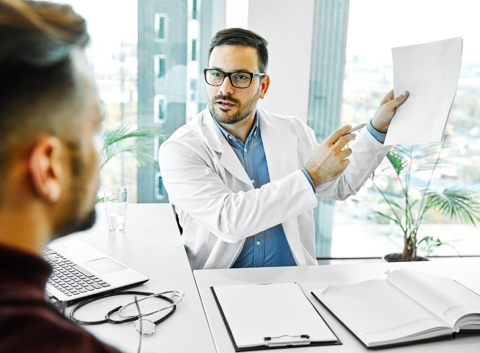 Doctor explaining how physical, emotional, and social factors contribute to depression.