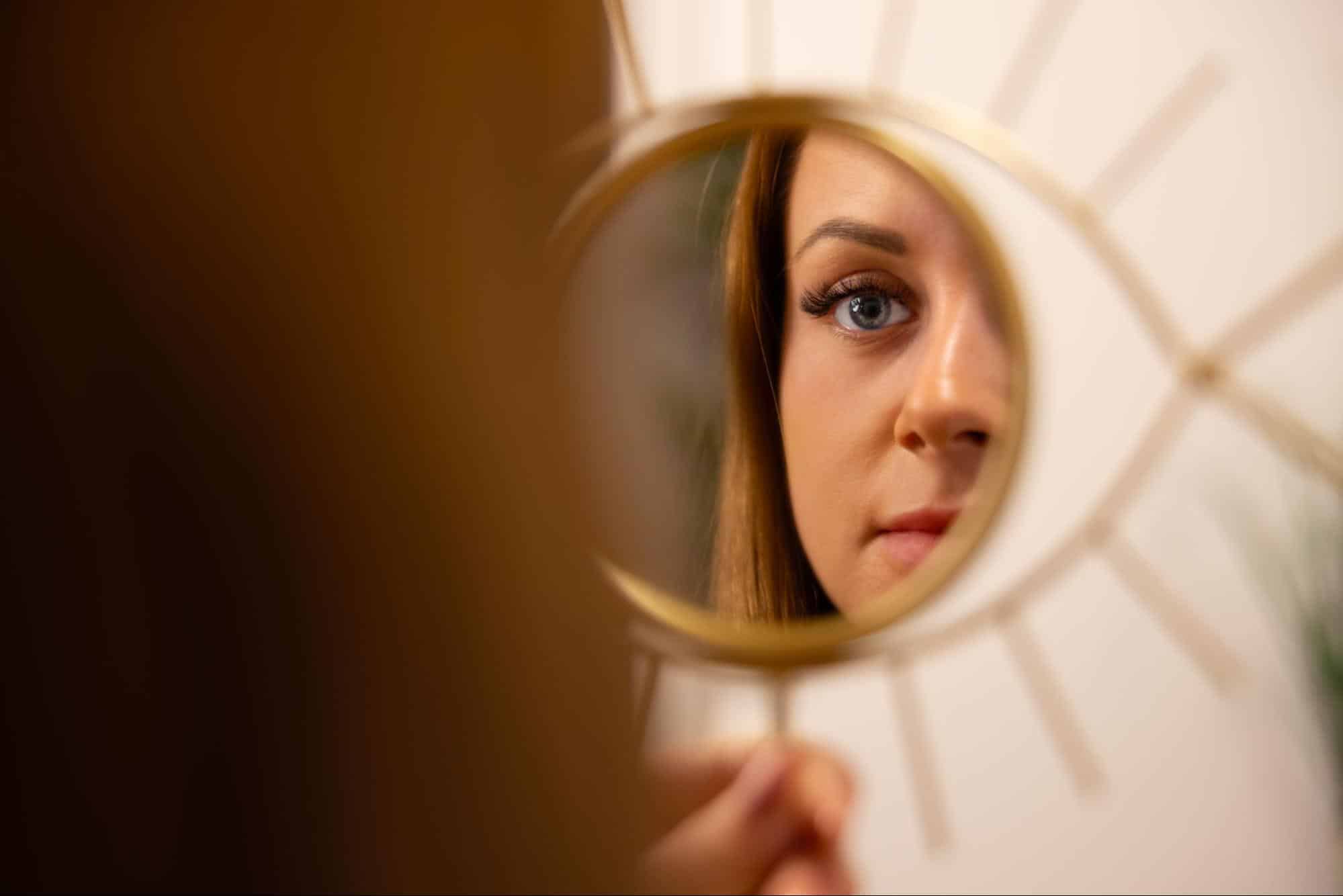 woman looking at self in a mirror