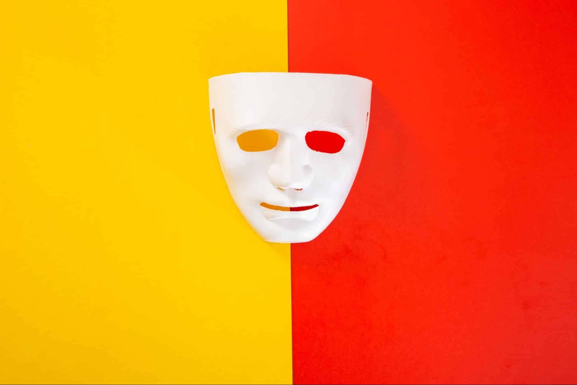 white mask on yellow and red background