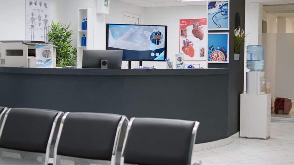 waiting room and reception counter of a health facility, representing affordable relationship-based care