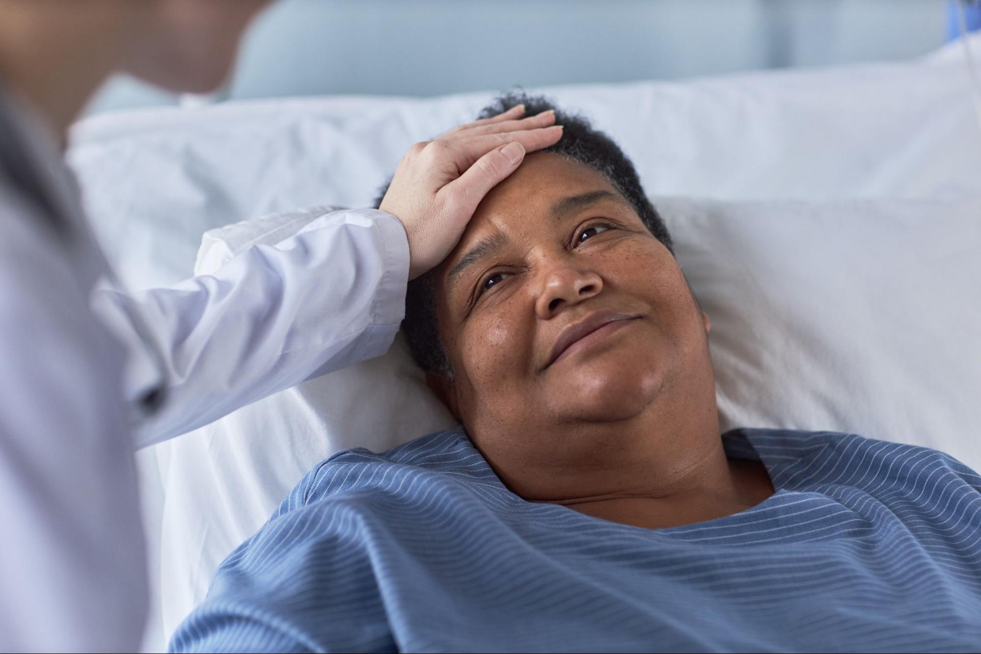 relationship-based primary care with nurse comforting senior patient during bedside visit
