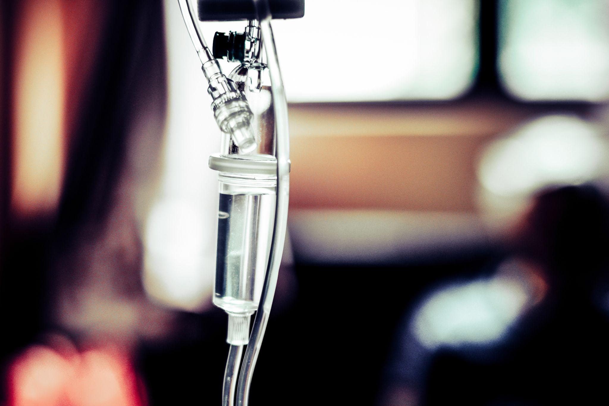 Close-up of IV drip chamber filled with liquid during infusion