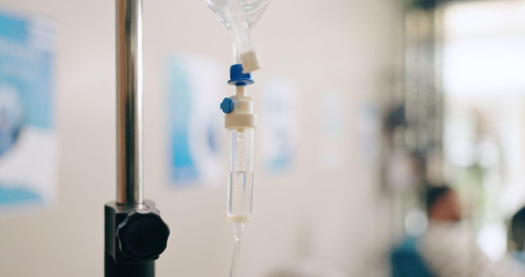 Close-up of IV drip equipment in a clinic setting