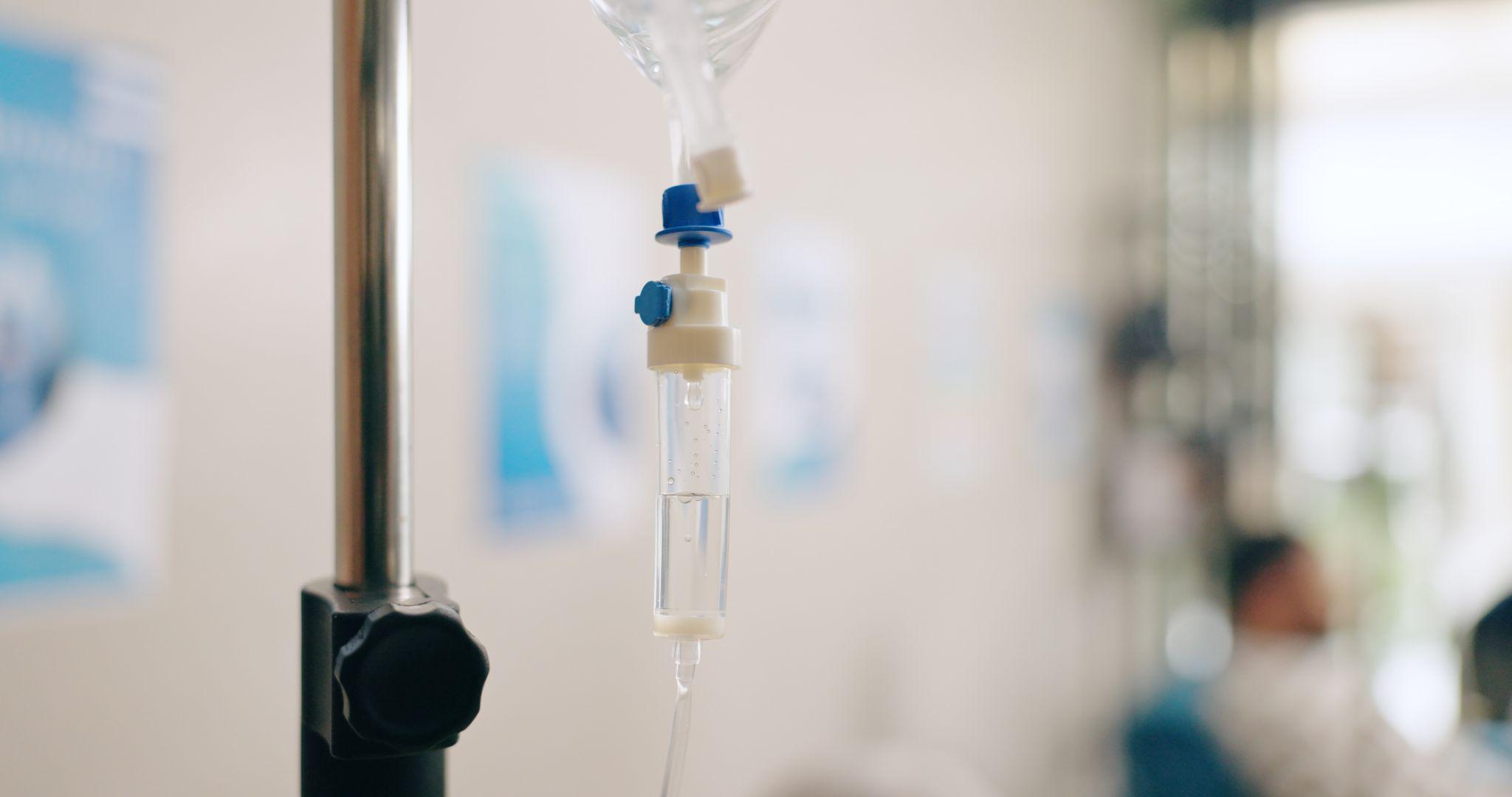Close-up of IV drip equipment in a clinic setting
