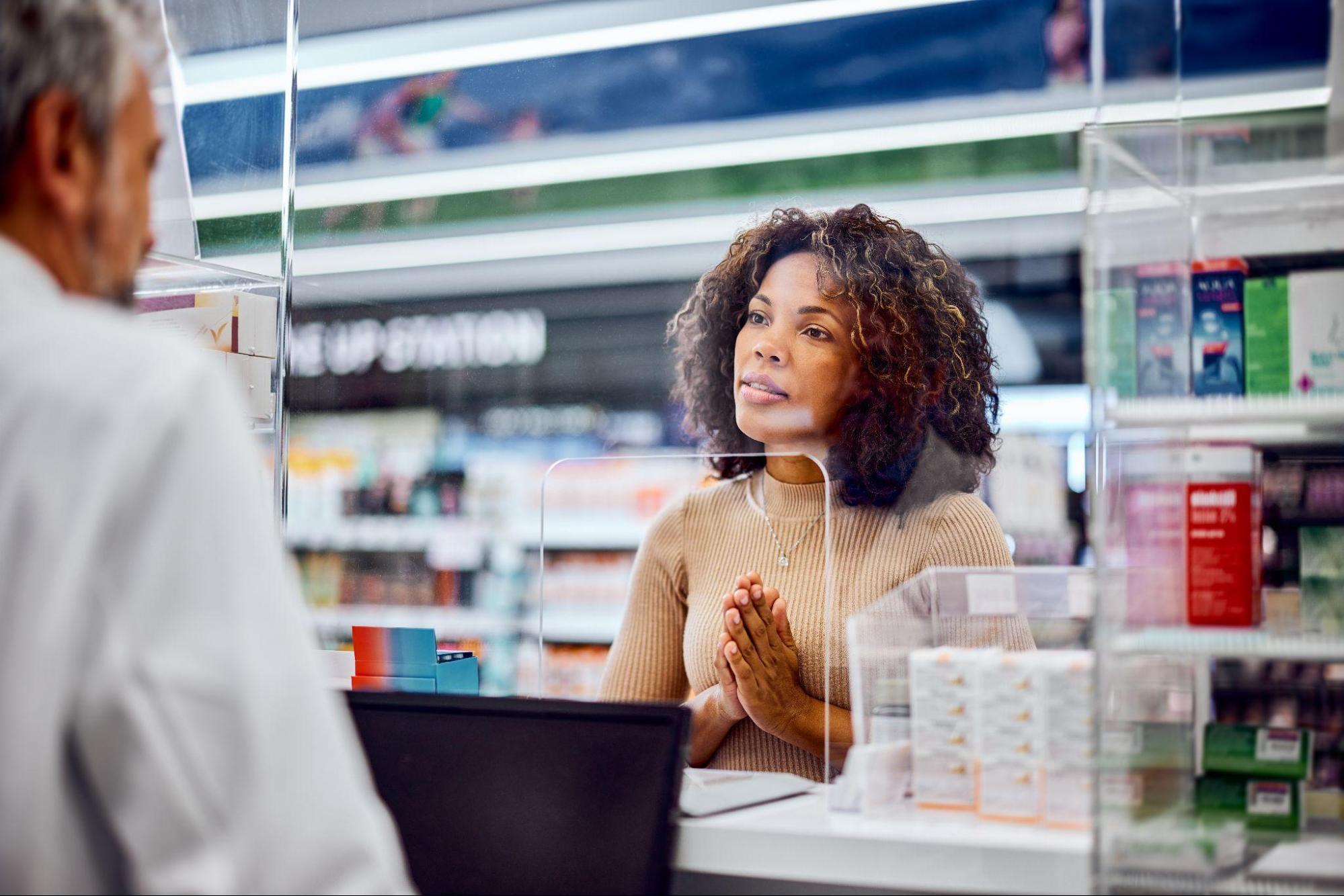 Woman speaking with a pharmacist about medication options and guidance for scabies itch treatment. 