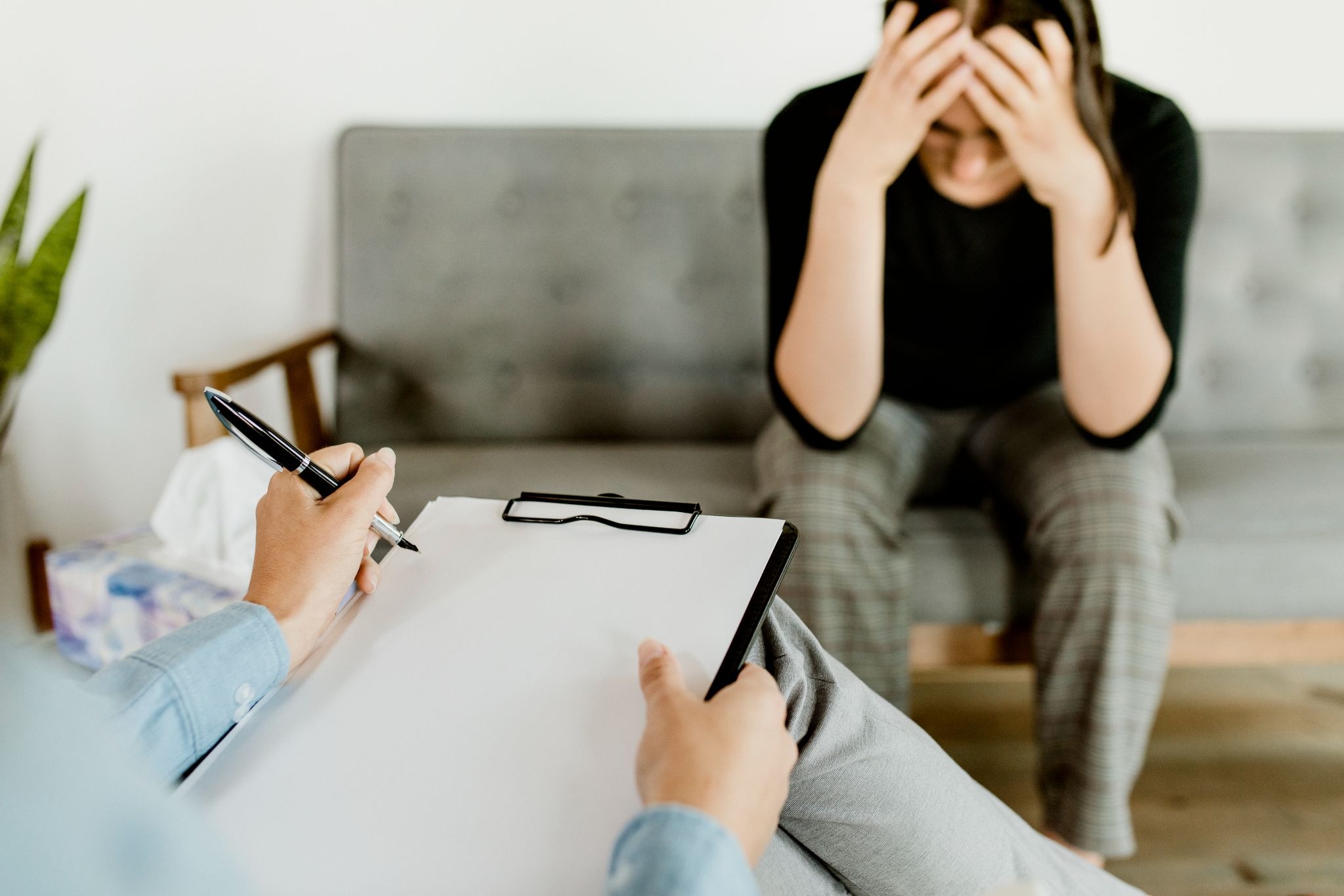 Adult patient discussing depression symptoms with a mental health professional while exploring treatment options.