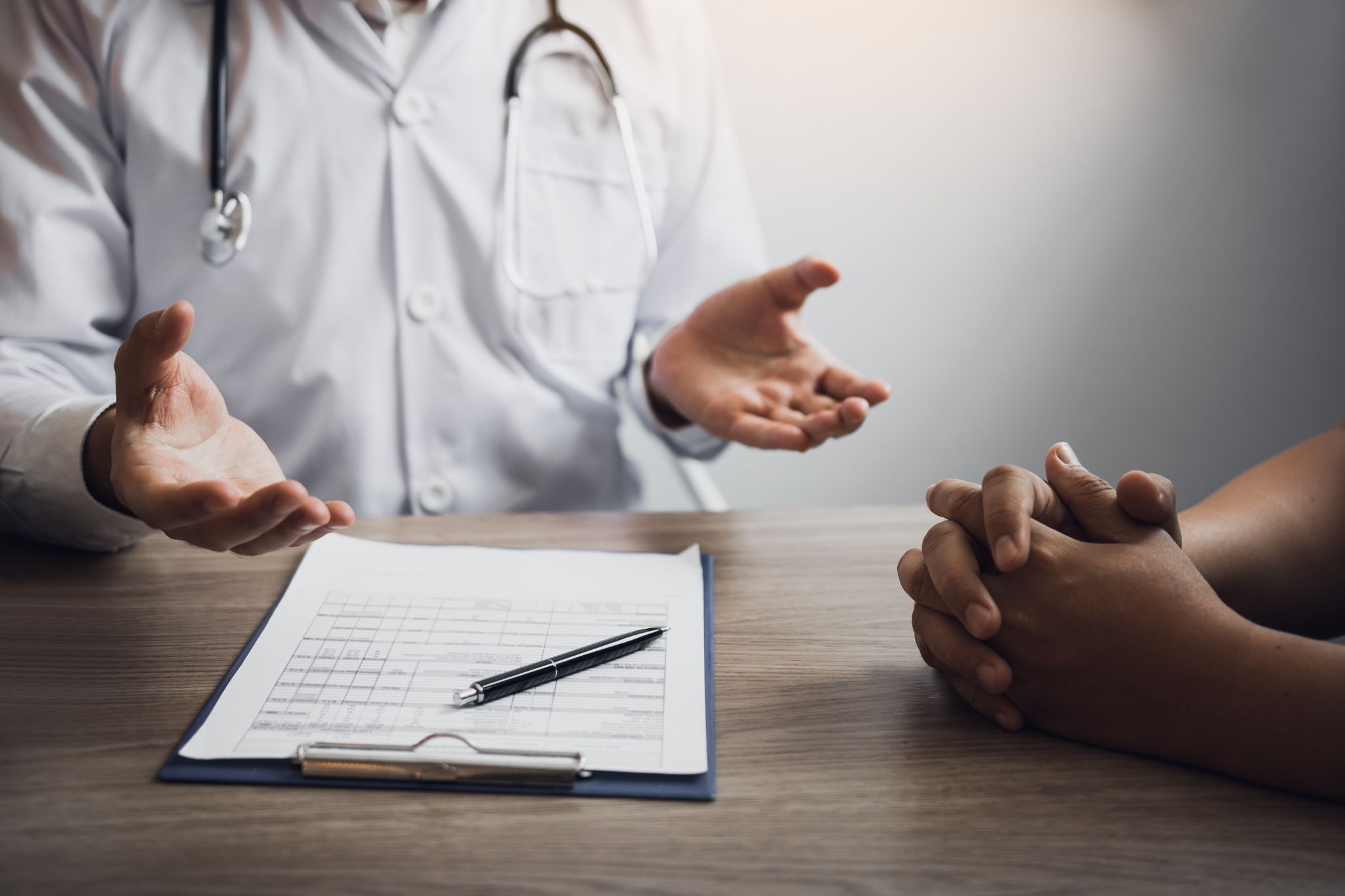 Doctor reviewing medical information with an adult patient during an evaluation for ketamine therapy.