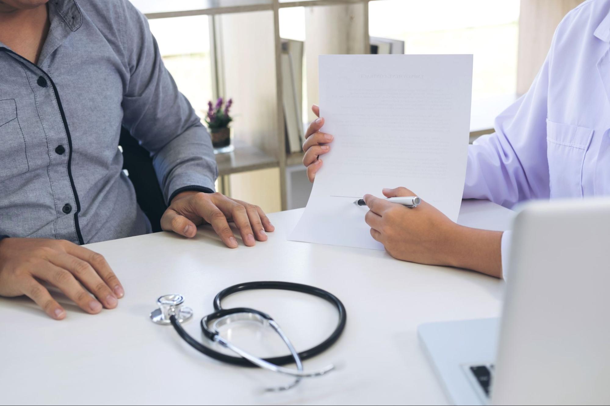 Doctor and patient discussing treatment options during a medical consultation for ketamine therapy.