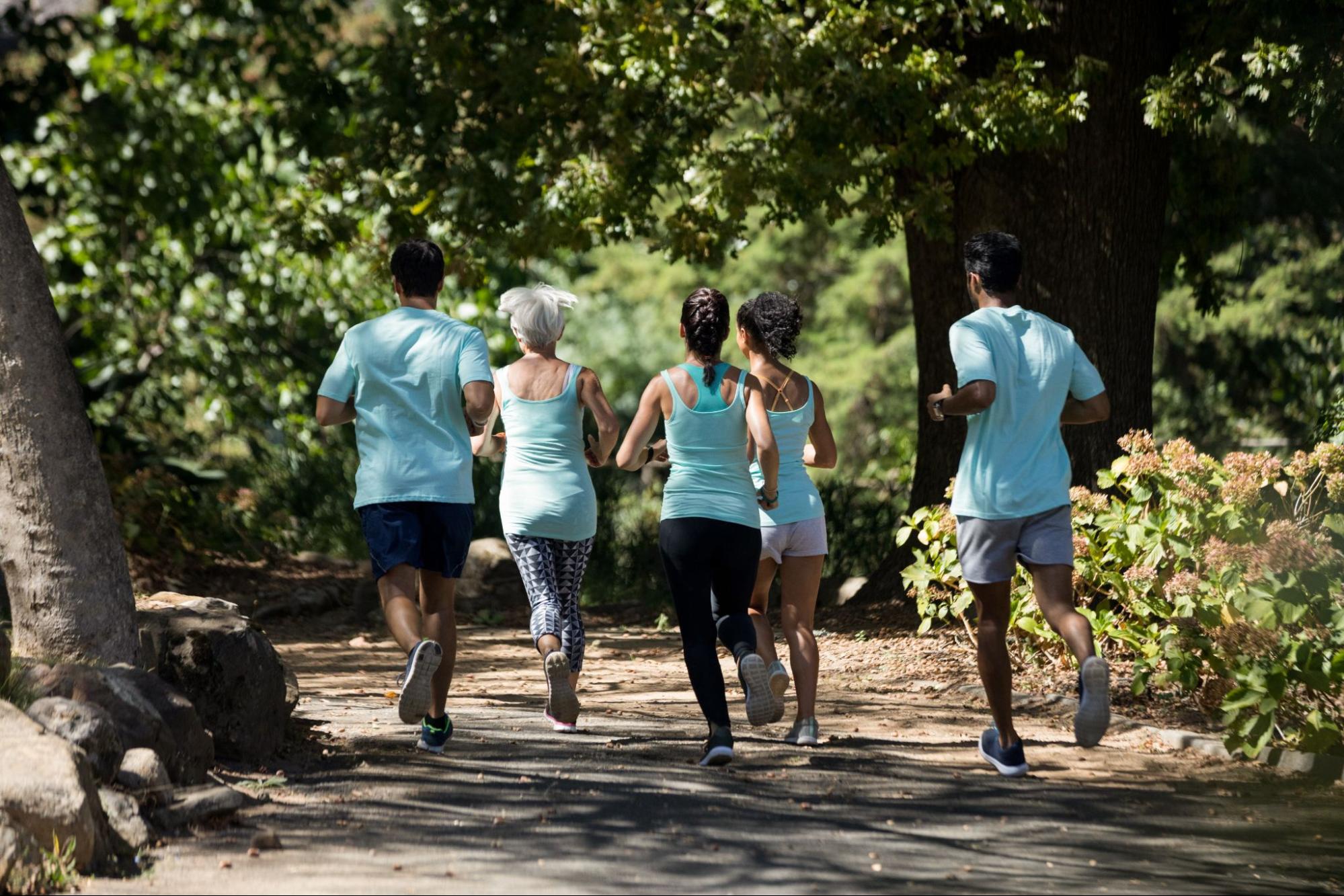 Group of adults jogging together in a park as part of an active lifestyle.