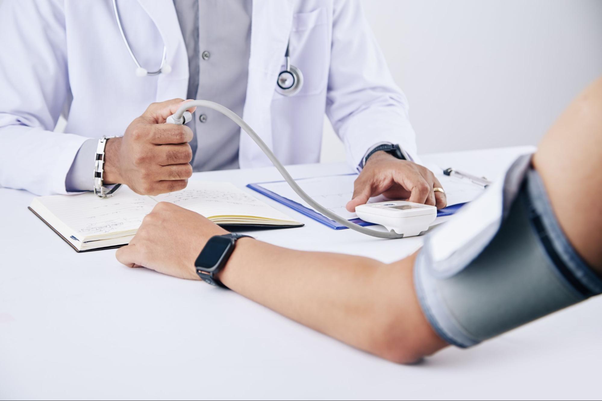 Doctor checking a patient’s blood pressure before ketamine treatment 