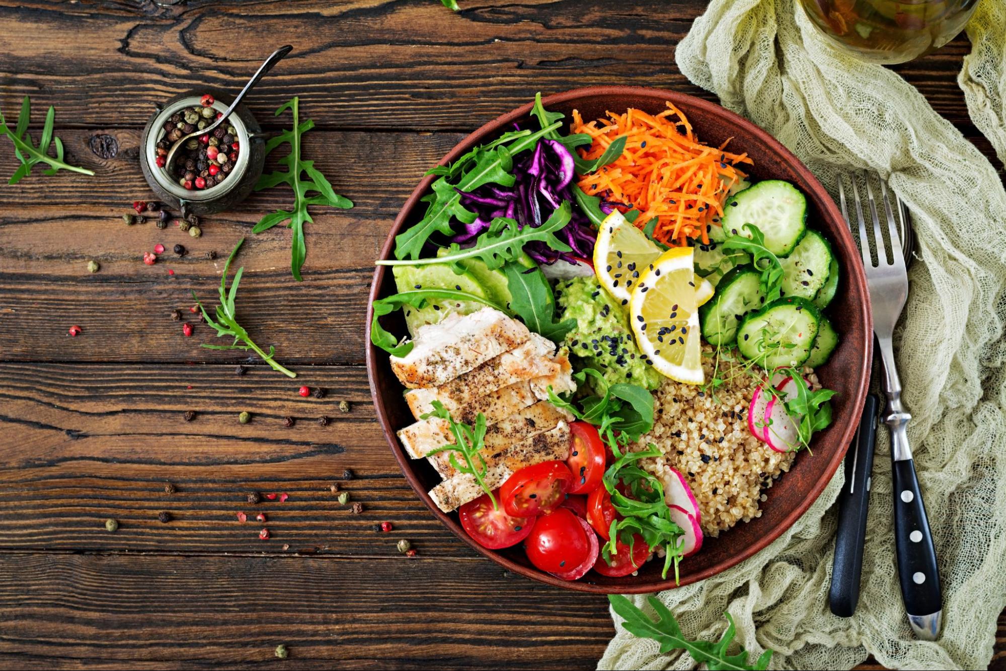 Healthy grain bowl with grilled chicken, vegetables, and whole grains.