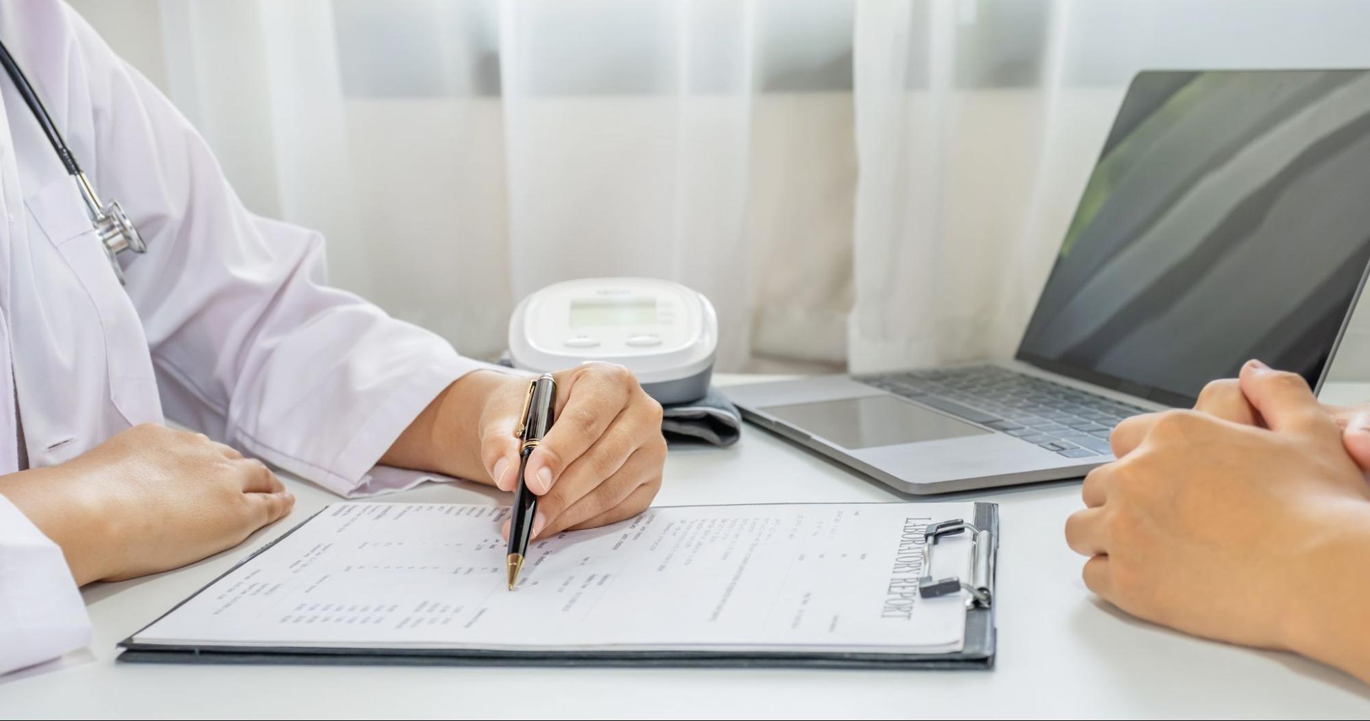 Healthcare professional reviewing patient information as part of physician-supervised ketamine care.