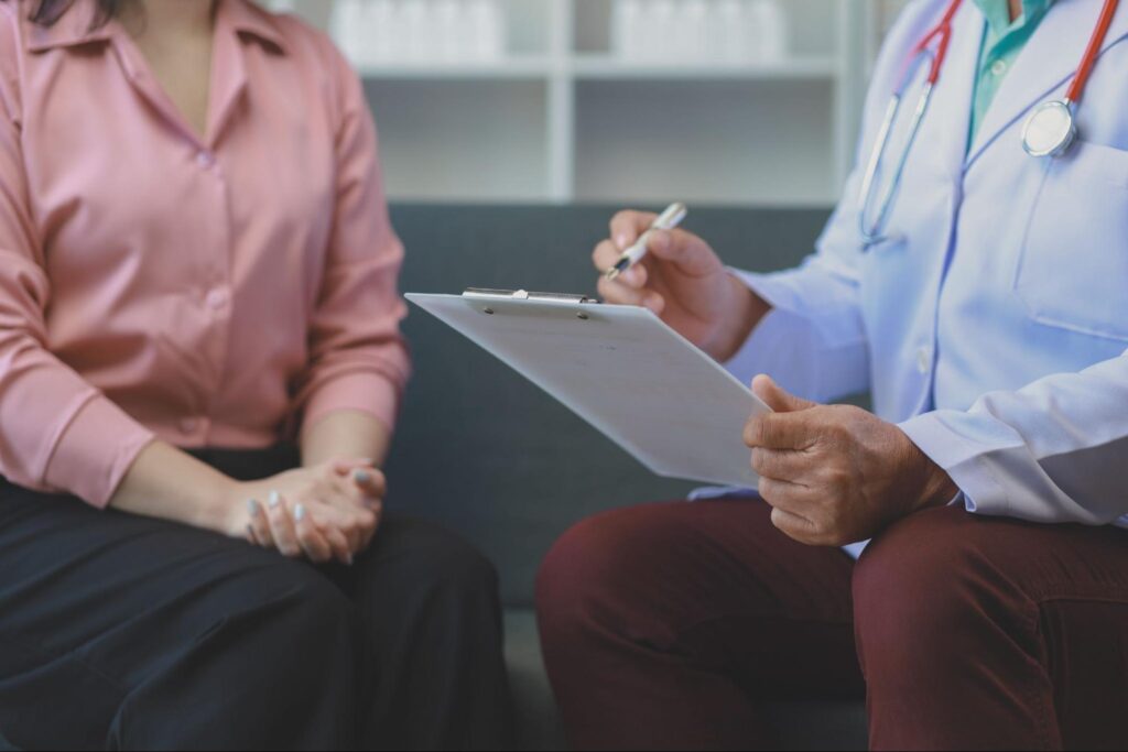 Adult patient discussing ketamine brain receptor effects with a physician 
